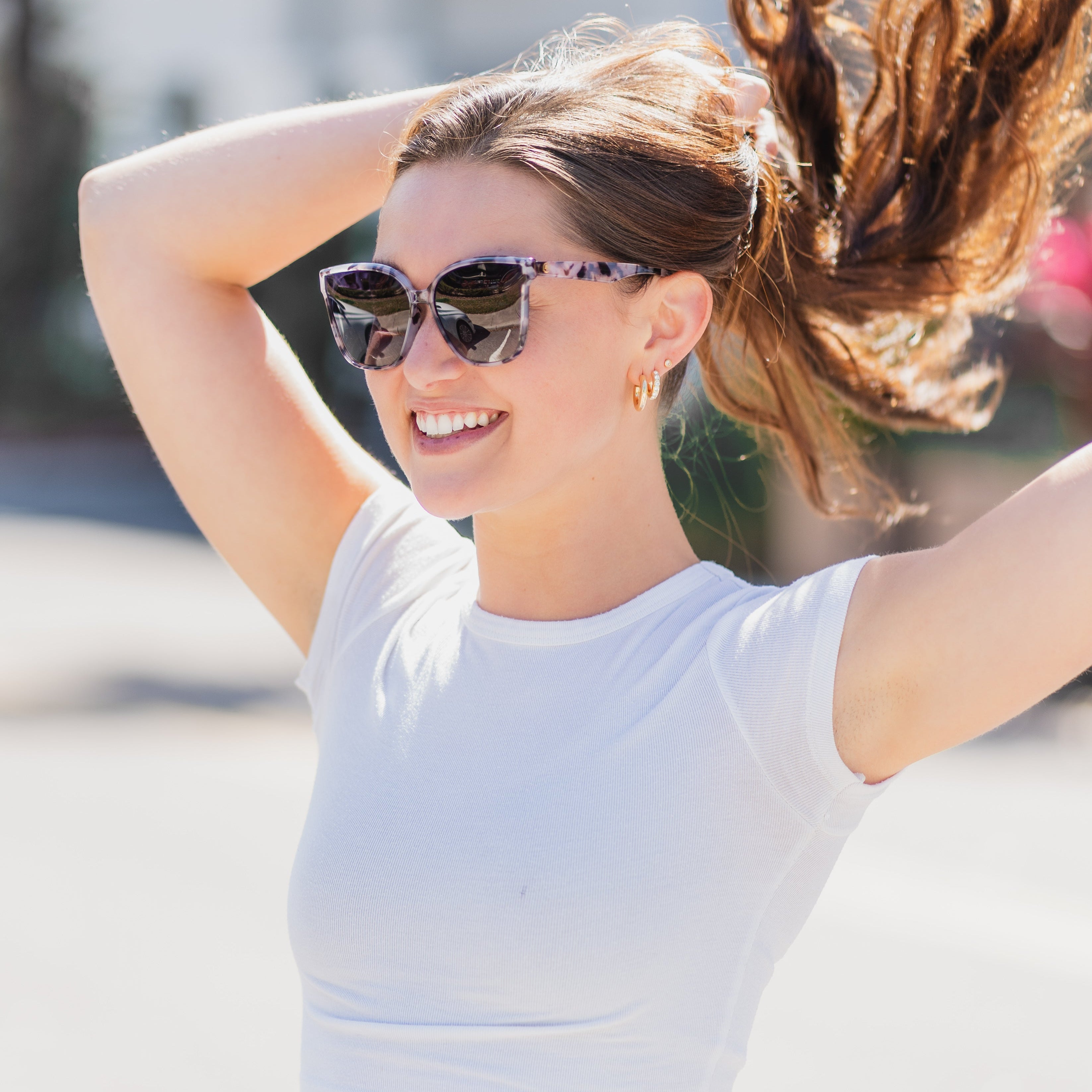 Woman wearing Epoch Eyewear Audrey sunglasses. 