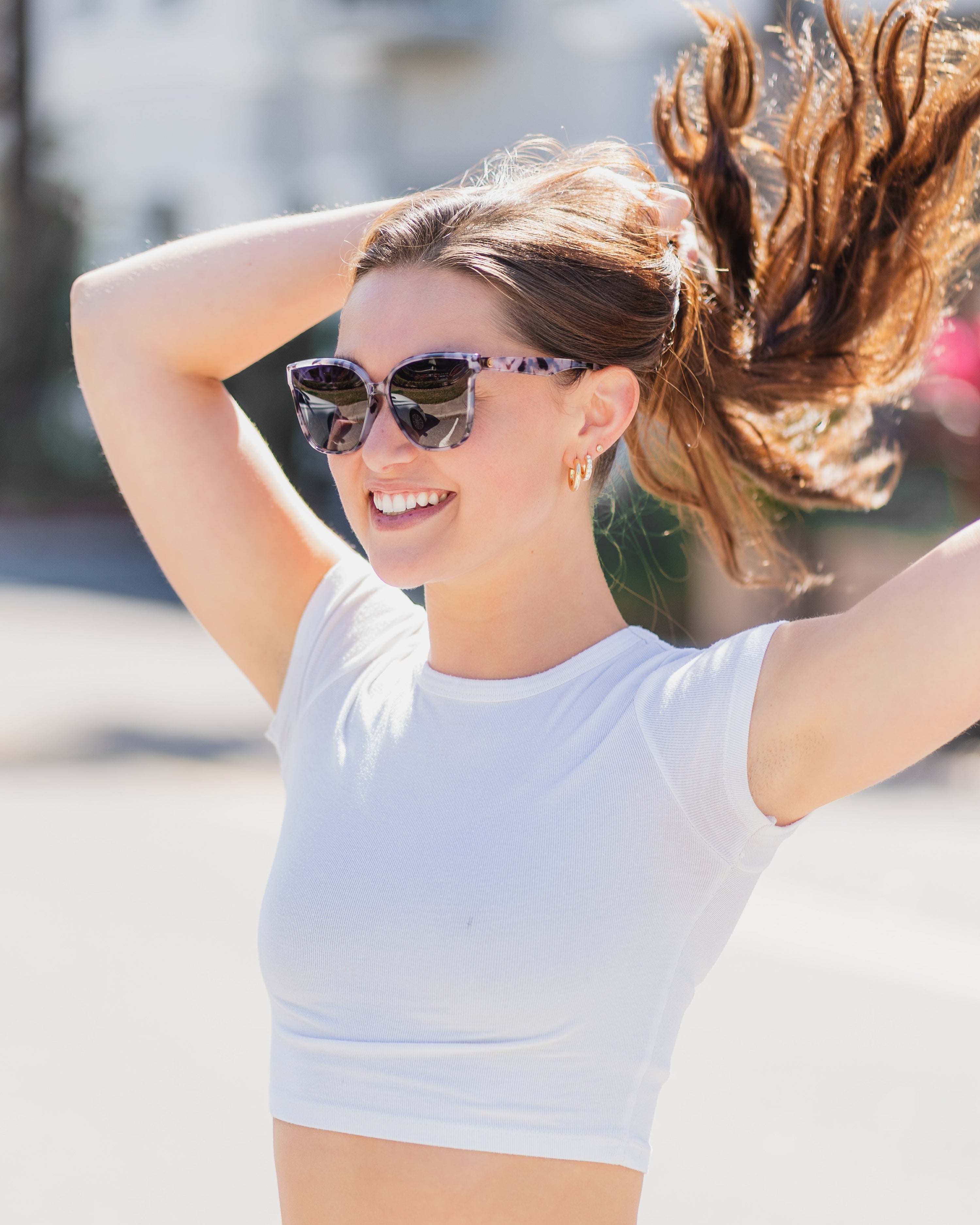 Woman wearing Epoch Eyewear Audrey sunglasses. 