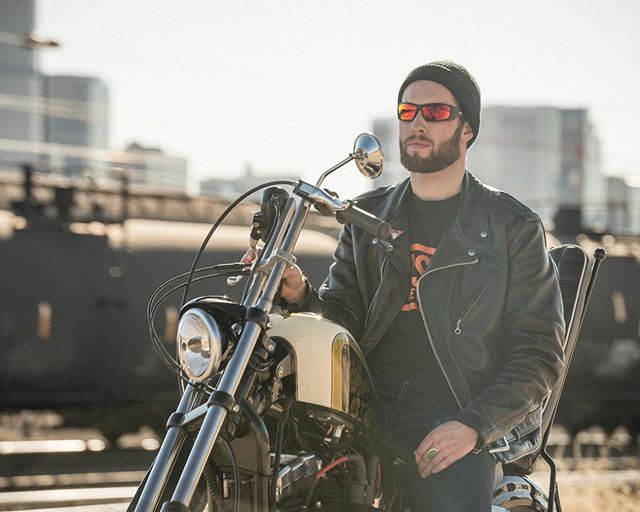 man with beanie riding motorcycle wearing liberator sunglasses