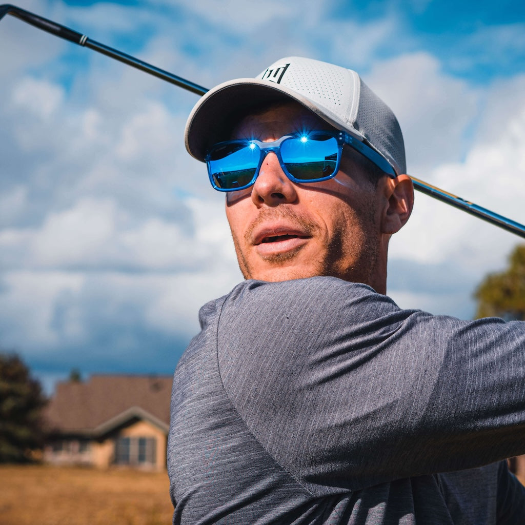 man golfing wearing blue romeo sunglases