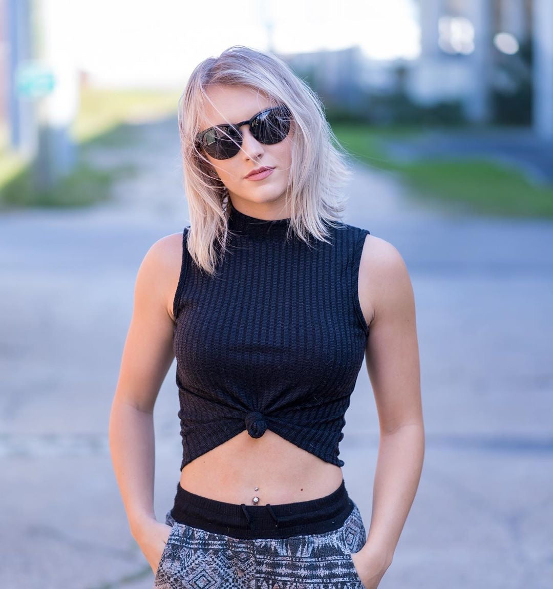 woman with sleeveless top wearing black sierra sunglasses